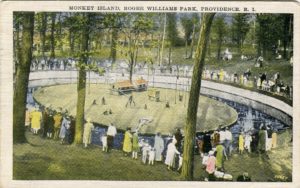 Postcard of Monkey Island at Roger Williams Park, Providence, R.I., 1920s. People gather around a monkey enclosure with trees.