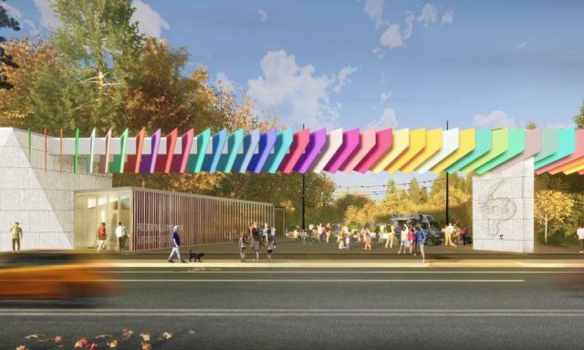 A colorful architectural structure with vibrant panels spans a walkway at Roger Williams Park Visitor Center. People and a dog are nearby.