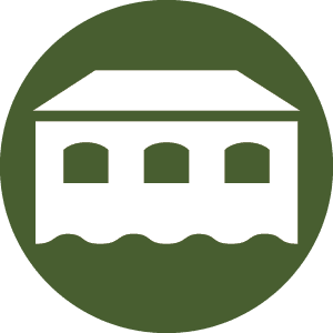 A white house icon with three arched windows on a green circle background, labeled "rwp-icon-seal-house-1-color-1."