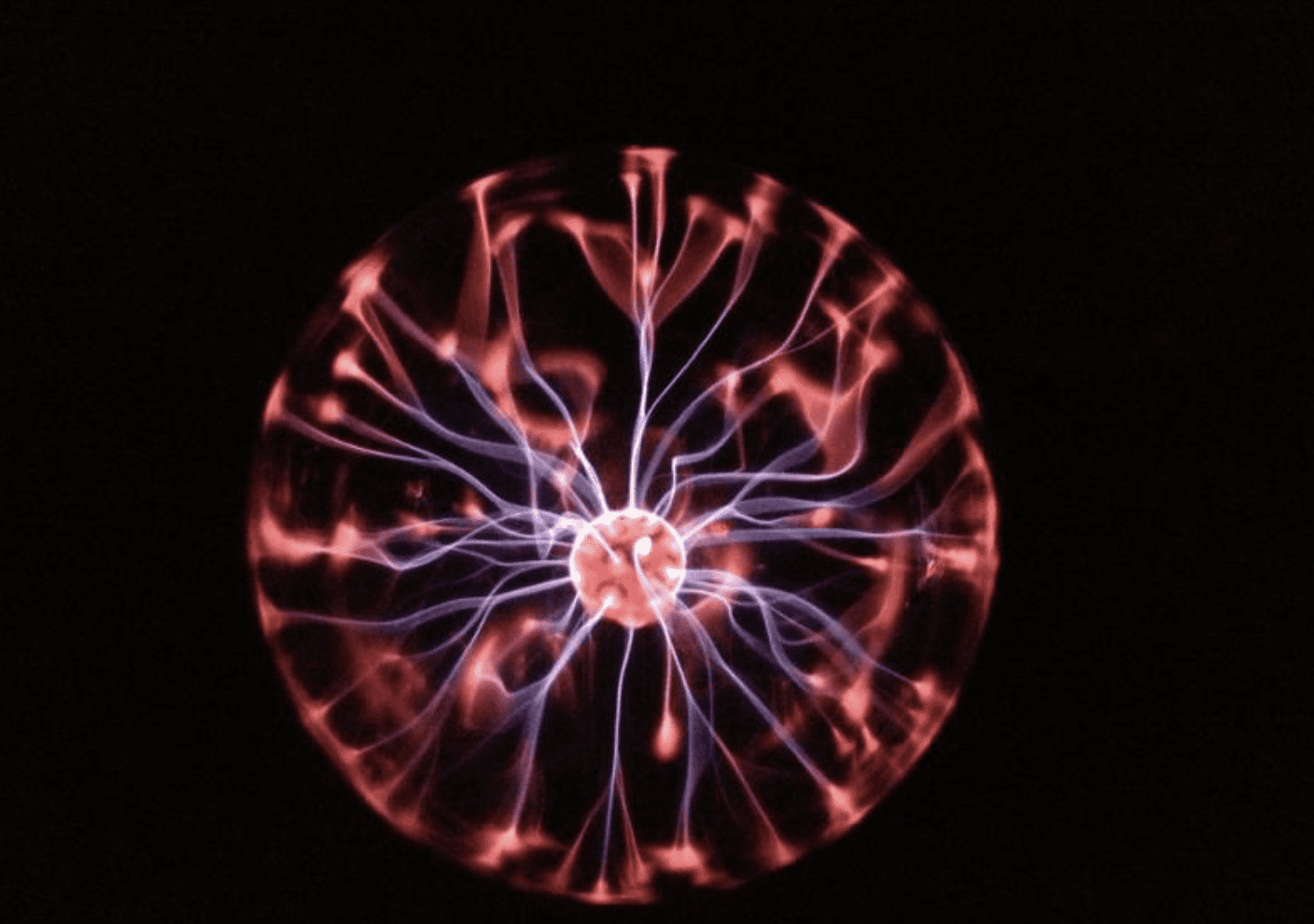 A glowing plasma globe with pink and purple tendrils extending from the center against a dark background.