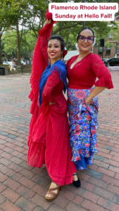 Two women in vibrant flamenco attire pose outdoors. Text reads: "Flamenco Rhode Island Sunday at Hello Fall!"
