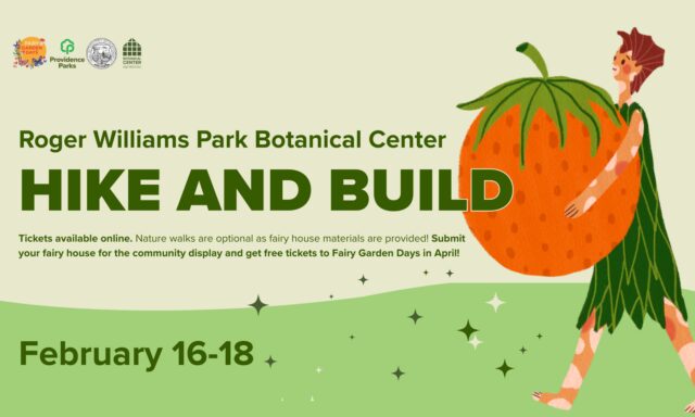 A person carries a large orange while promoting a hiking and building event at Roger Williams Park Botanical Center.
